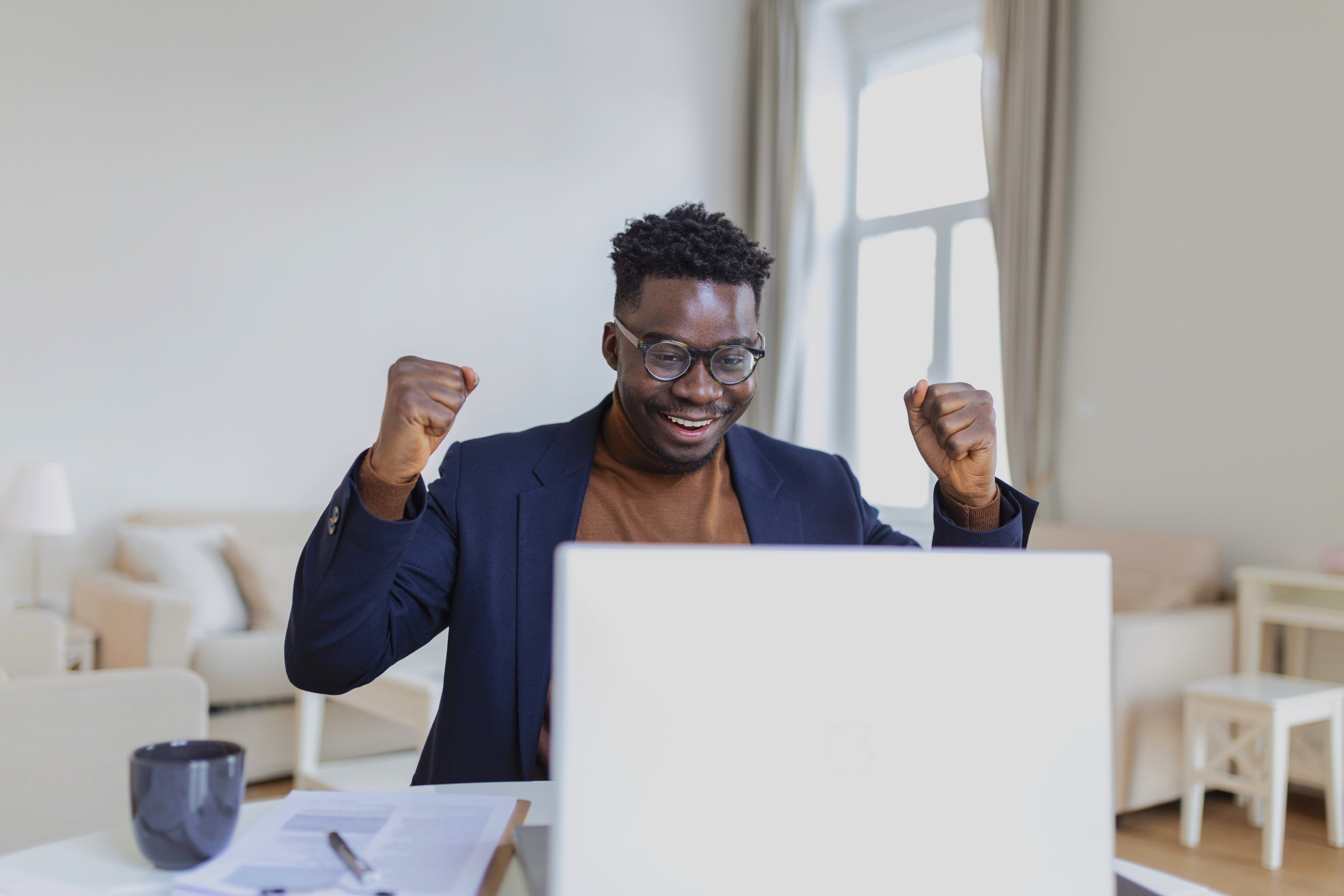 Excited man using laptop
